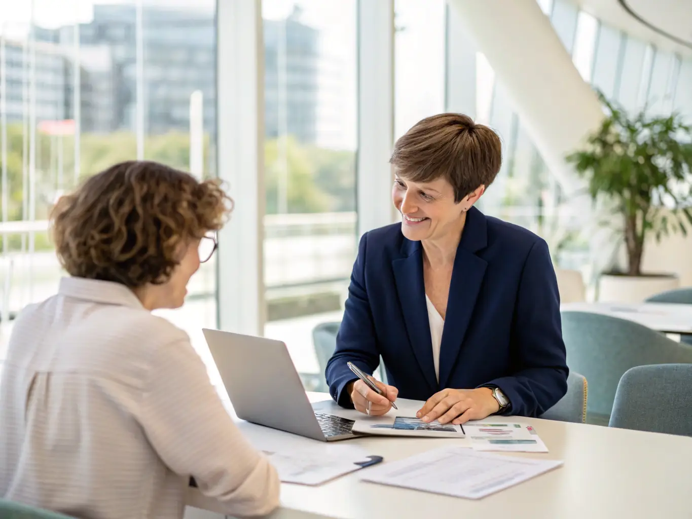 An image of a financial advisor providing business advice to a client in a modern office setting, symbolizing business advisory services.
